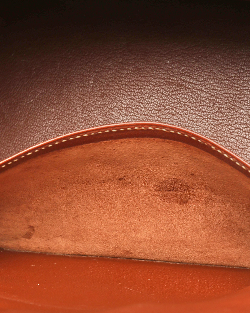 Close-up view of the interior slip pocket of the Hermès Birkin 30 bag, showing light traces of use on the brown leather.