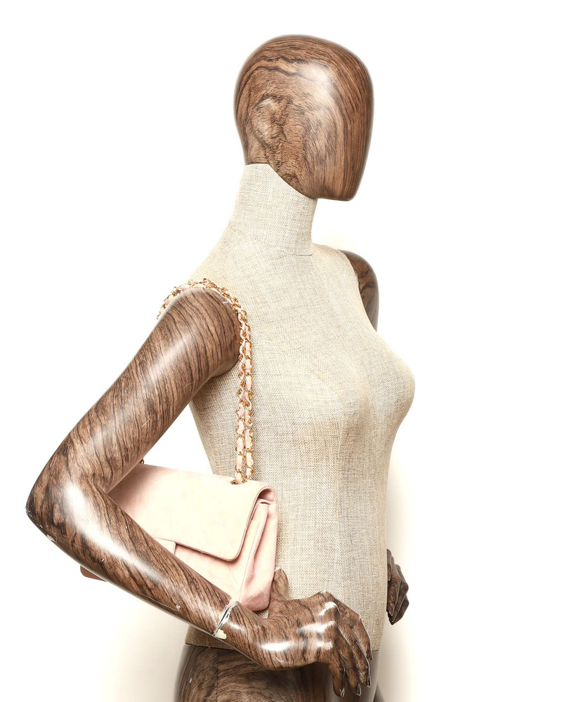 Chanel Classic Medium Suede Double Flap Bag worn on a mannequin's shoulder.