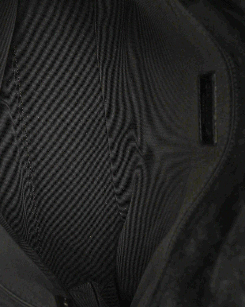 Interior view of the Chanel CC Suede Flap Bag, showing the fabric lining and interior pocket.