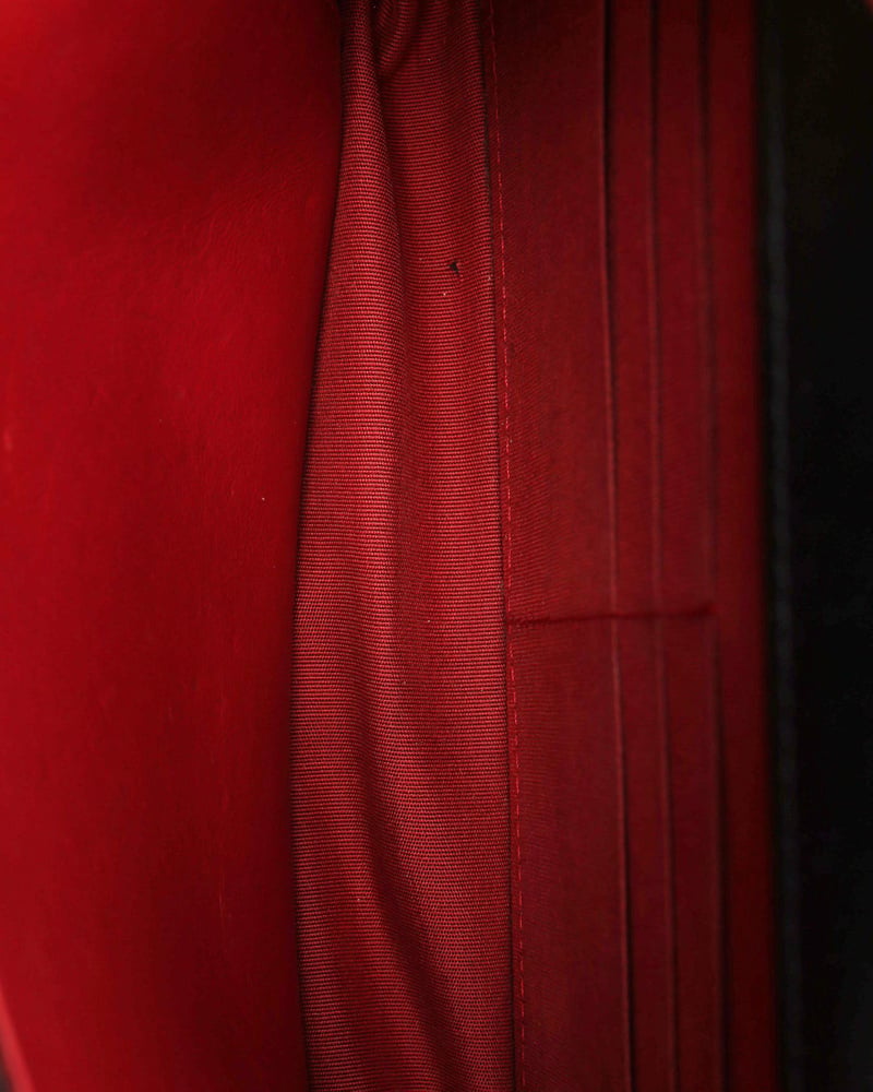 Interior view of the Chanel Wallet on Chain Bag showing the red fabric lining and card slots.