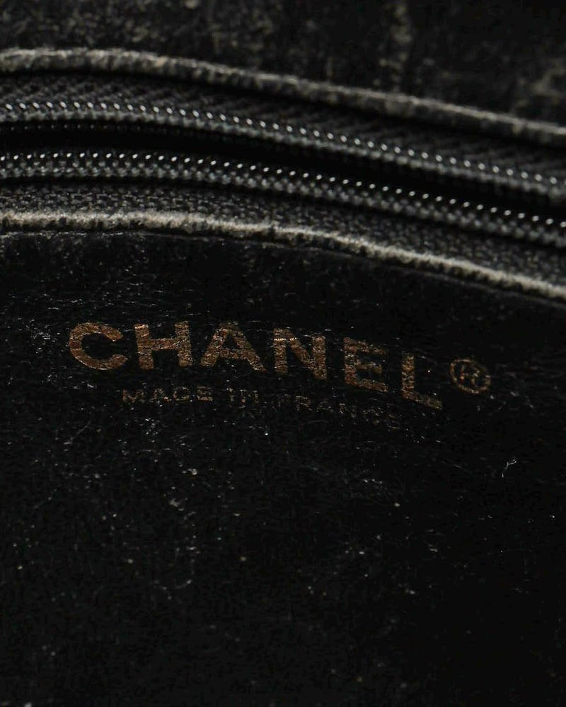 Interior close-up of a Chanel CC Medallion Caviar Tote Bag showing the brand logo stamp