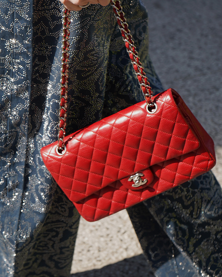 Yellow Fendi handbag with white FF logo pattern, surrounded by yellow flowers