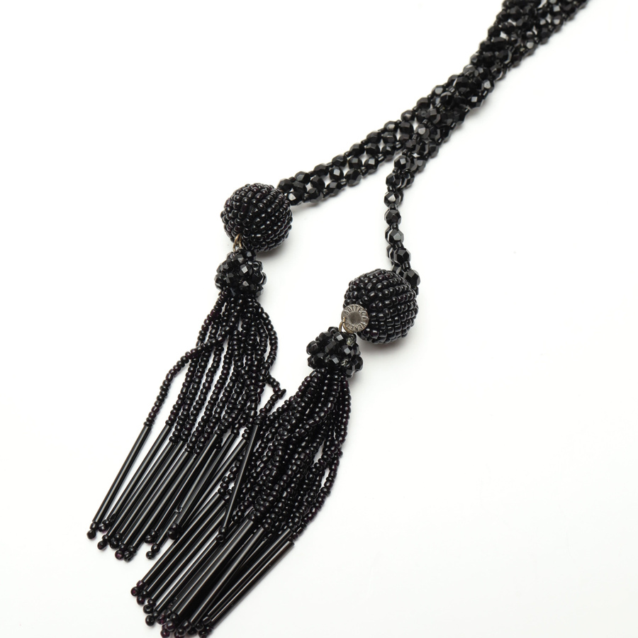 Vintage Bottega Veneta Tassel Necklace in black. Full view of the beaded lariat style with two tassels on a white background.