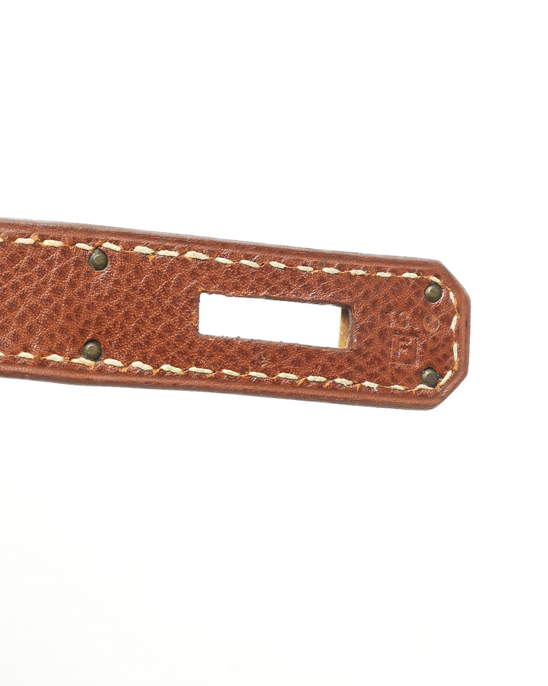 Close-up view of the Square F blind stamp on the brown Courchevel leather strap of the Hermès Birkin 30 bag.