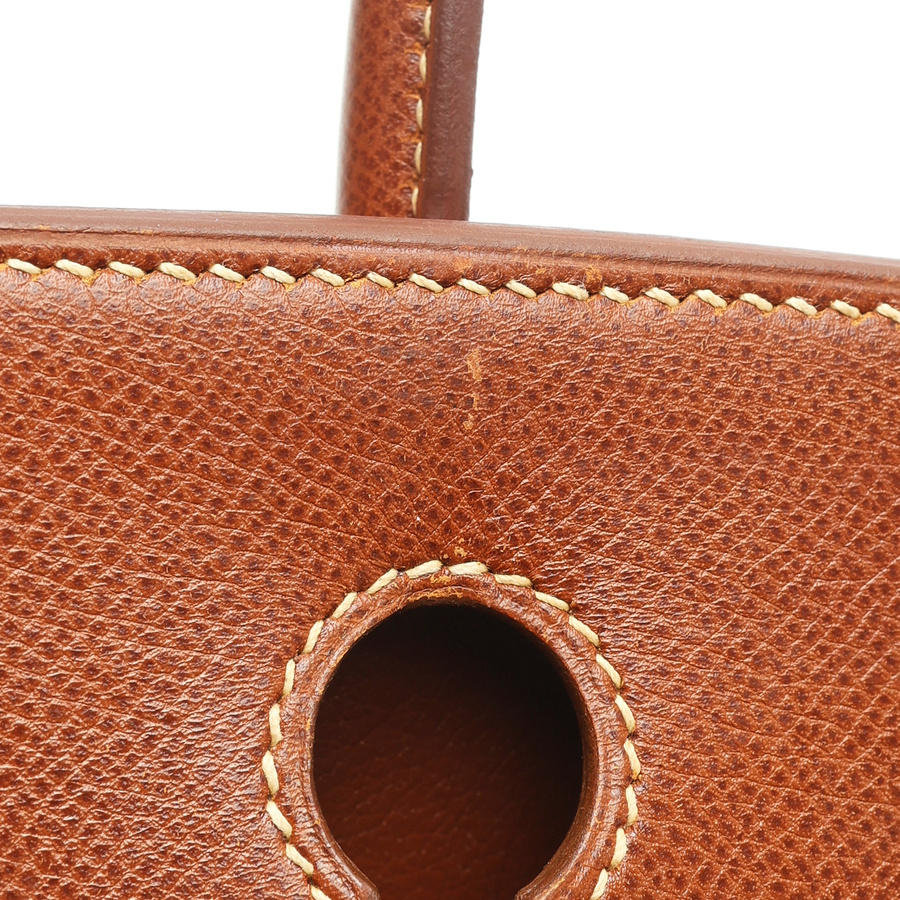 Close-up shot of the Hermès Birkin 30, showing the meticulous stitching on the brown Courchevel leather around the lock opening.