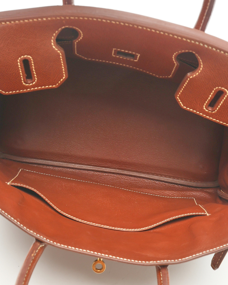 Close-up interior view of the Hermès Birkin 30 Courchevel Bag, showing the brown leather lining and front slip pocket.