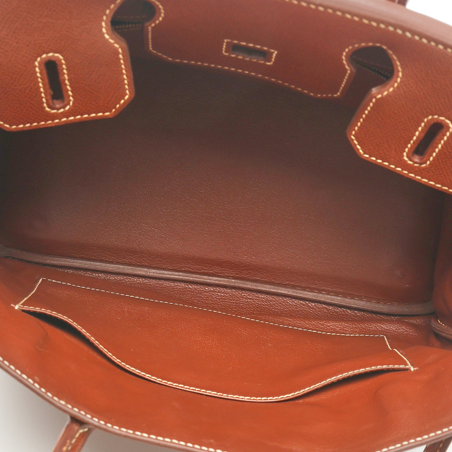 Close-up interior view of the Hermès Birkin 30 Courchevel Bag, showing the brown leather lining and front slip pocket.