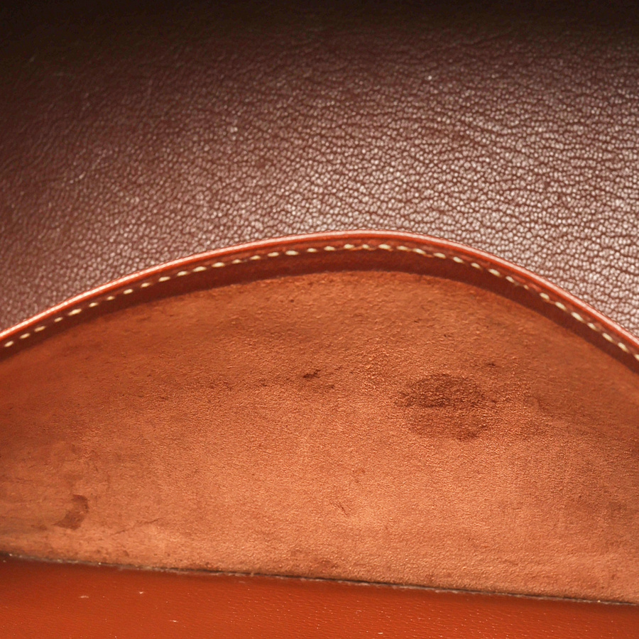 Close-up view of the interior slip pocket of the Hermès Birkin 30 bag, showing light traces of use on the brown leather.