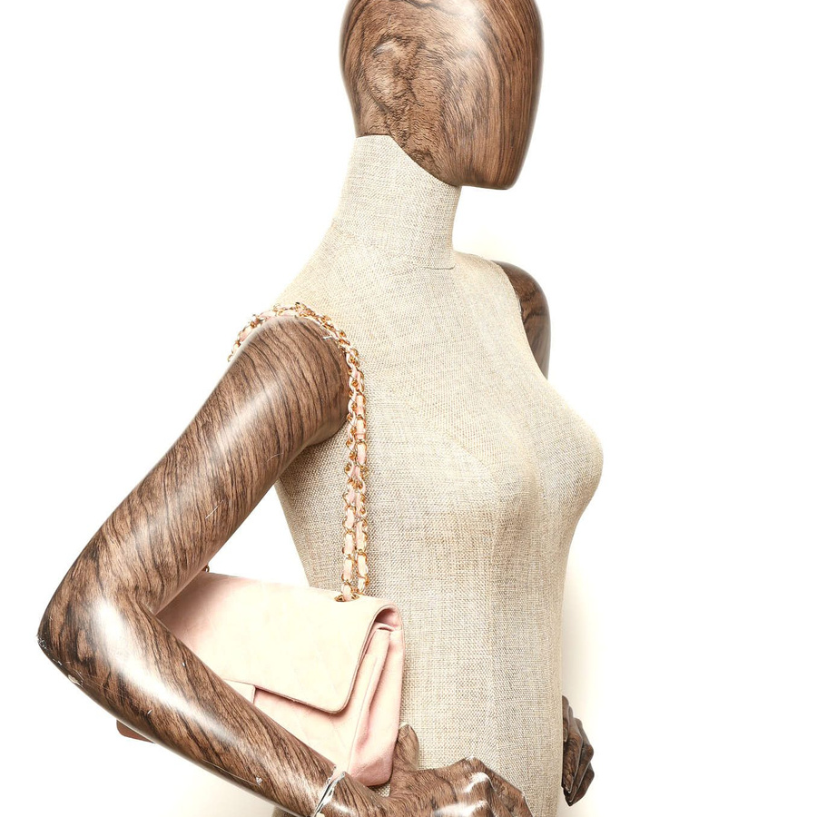 Chanel Classic Medium Suede Double Flap Bag worn on a mannequin's shoulder.