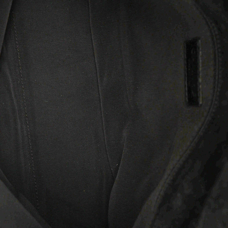 Interior view of the Chanel CC Suede Flap Bag, showing the fabric lining and interior pocket.