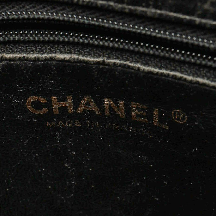 Interior close-up of a Chanel CC Medallion Caviar Tote Bag showing the brand logo stamp