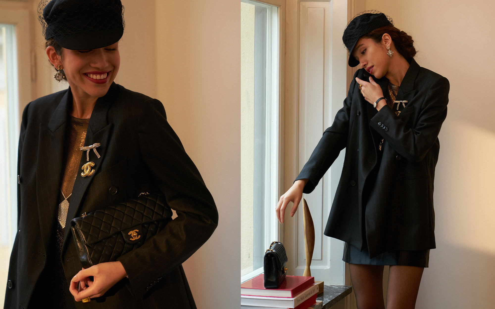 A person dressed in an elegant black outfit and veiled hat, accessorized with statement earrings and brooches. In the first view, they smile while holding a quilted black handbag with gold hardware. In the second view, they stand by a window, reaching toward the handbag resting on a stack of books.