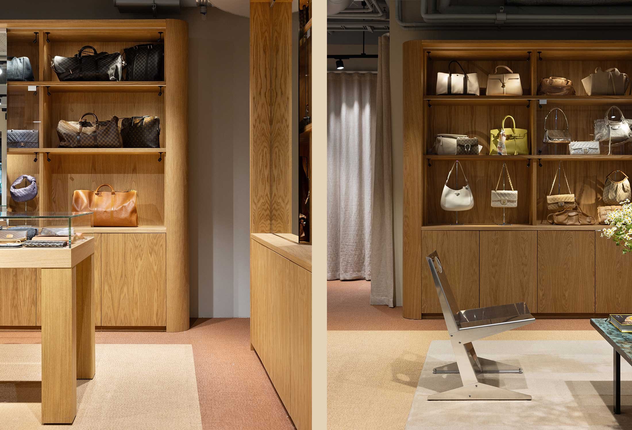 Interior view of a luxury boutique featuring wooden shelves displaying designer handbags and travel bags, with a modern metal chair and glass display table in the foreground.